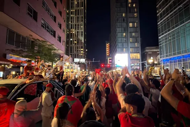 Boston Dons 'Red'... and 13 Planes Carry Moroccan Fans